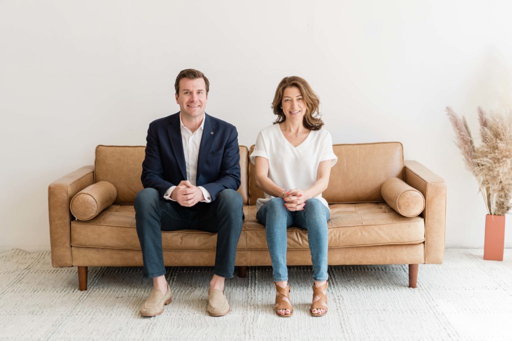 couple sitting on leather couch together